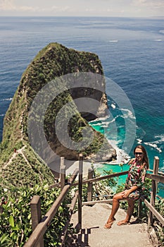 Pretty girl is traveling on kelingking bay, the island of Nusa Penida, Indonesia