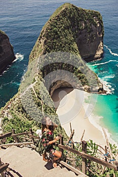 Pretty girl is traveling on kelingking bay, the island of Nusa Penida, Indonesia