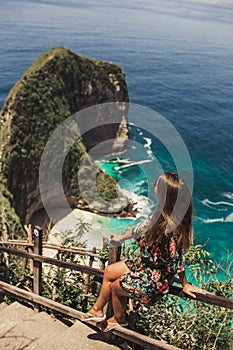 Pretty girl is traveling on kelingking bay, the island of Nusa Penida, Indonesia