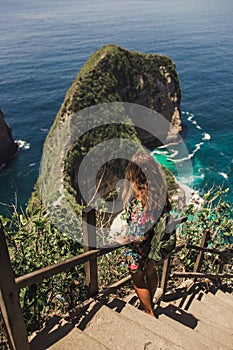 Pretty girl is traveling on kelingking bay, the island of Nusa Penida, Indonesia