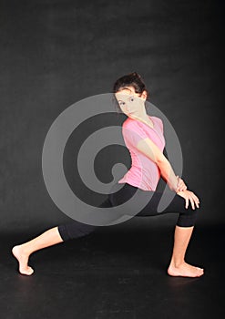 Pretty girl trying to exercise yoga - warrior pose