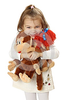 Pretty girl with two toy monkeys in hands