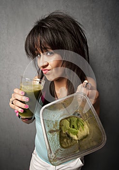 Pretty girl with unappetizing health shake