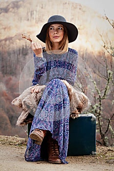 Pretty girl with vintage case on a dirtroad