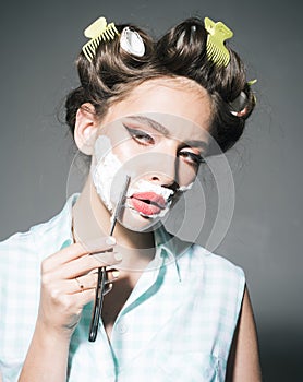 Pretty girl in vintage style. retro woman shaving with foam and razor blade. pin up woman with trendy makeup. pinup girl