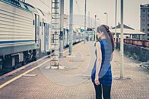 Pretty girl walking along the tracks