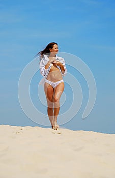 Pretty girl walking on the beach.