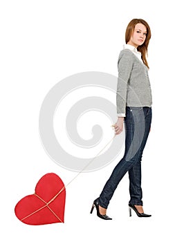 Pretty girl walking with bounded heart photo