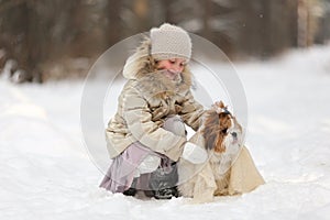 Pretty girl in warm wool clothes, with cold winter iced background with expressive emotions on her beautiful face, winter portrait