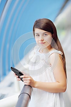 Pretty girl in white blouse with tablet pc looks