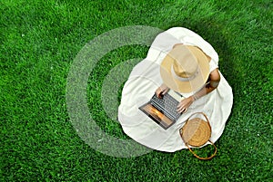 Pretty girl in white dress and hat drinking tea