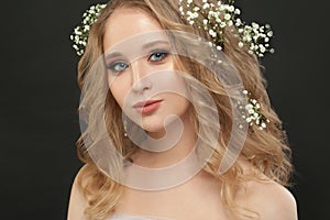 Pretty girl with white flowers on black, beautiful face closeup