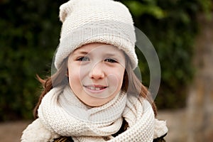 Pretty girl with wool hat in a park