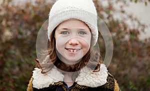 Pretty girl with wool hat in a park