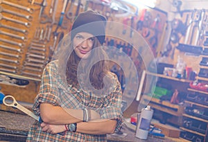 Pretty girl in the workshop with a tool