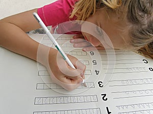 Pretty girl writening math homework