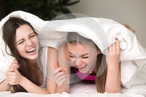 Pretty girlfriends fooling around in bed