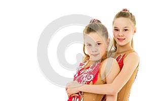 Pretty Girls Gymnasts Performing Rhythmic Gymnastics Exercise.