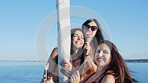 Pretty girls make selfie on a yacht - party and bachelorette party