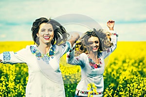 Pretty girls outdoor walking in the field in embroidery shirts