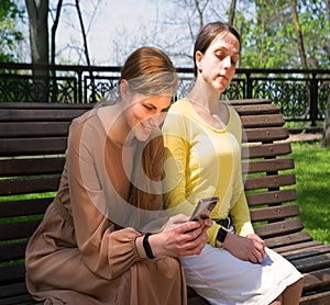 Pretty girls sitting on the bench