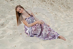 Pretty gorgeous woman smiles on sand