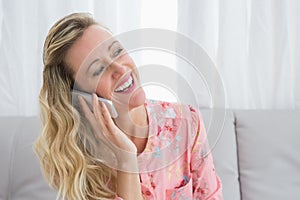 Pretty happy blonde phoning with mobile phone