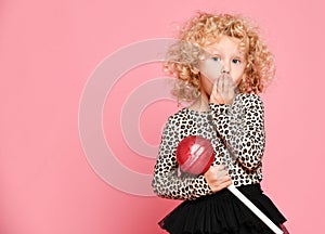 Pretty happy curly blonde hair young little child girl hold huge sweet lollypop candy surprised screaming yelling on pink