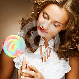 Curly girl with a lollipop in her hand