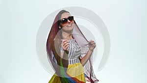 Pretty happy smiling woman with her hands up in the air playing with beautiful silk scarf against on a white background