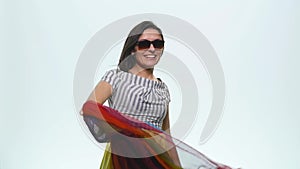 Pretty happy smiling woman with her hands up in the air playing with beautiful silk scarf against on a white background