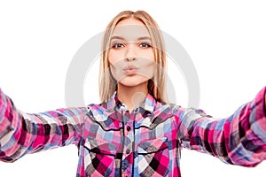 Pretty happy young woman making selfie and pouting