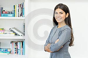 Pretty hispanic businesswoman with crossed arms