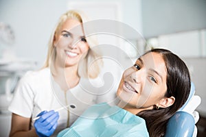 Cute happy patient in an orthodontic clinic photo