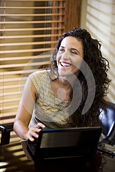 Pretty Hispanic woman using laptop computer