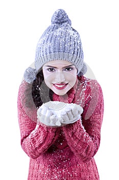 Pretty indian woman holding snow