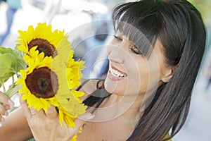 Pretty Italian Woman Looking at Sunflowers at Market