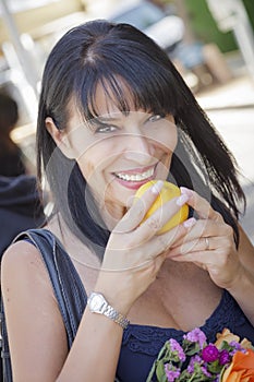 Pretty Italian Woman Smelling Oranges at the Street Market