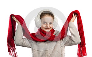 Pretty joyful little girl in warm winter things with knitted scarf