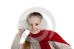 Pretty joyful little girl in warm winter things with knitted scarf