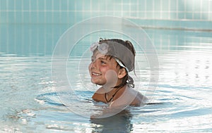 Pretty,joyful, smiling little girl enjoying her swimming time