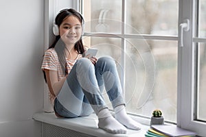 Pretty korean girl schooler spending time alone at home