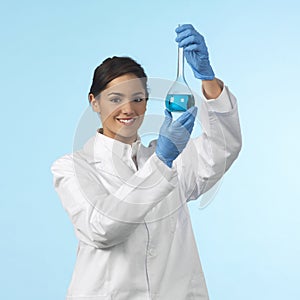 Pretty lab worker holding a chemistry flask