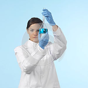 Pretty lab worker holding a chemistry flask