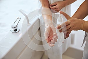 Pretty lady holding a cosmetic product after the water procedure