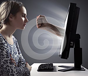 Pretty lady looking at the monitor - Internet violence symbol