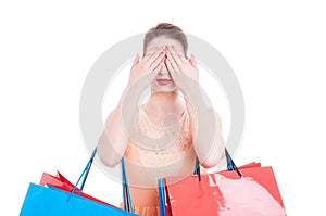 Pretty lady shopper covering her eyes with both hands