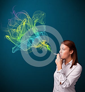 Pretty lady smoking cigarette with colorful smoke