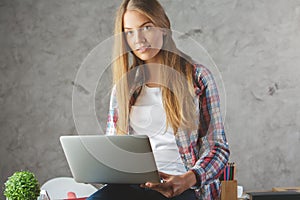 Pretty lady using laptop at workplace