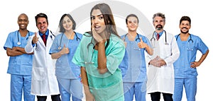 Pretty latin american female nurse with doctor and medical team